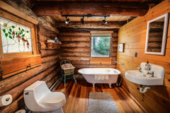 Cabin interior bathroom with wood walls.