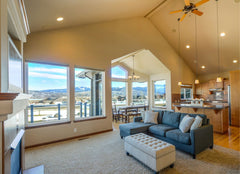 Large open floor plan living room and kitchen with a ceiling fan