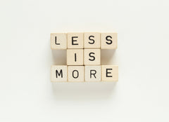 Less Is More written in blocks on a white background.