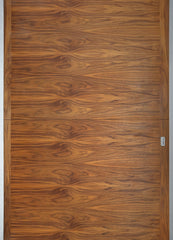 Close up image of a wood panel door.