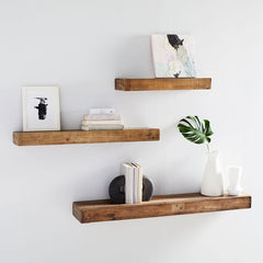Reclaimed wood floating shelves with decorative items on them.
