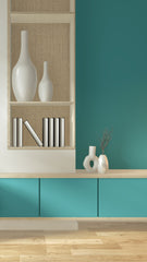 Teal walls, with a single built in bookcase in white.  The shelf has 2 large white vase and books on the shelves.