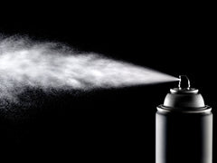Black and white photo of an aerosol can spraying