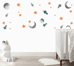 White wall with rocket ships, moons and stars wall decals