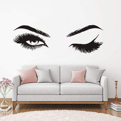 Sofa with large woman's eyes above, one eye is open, the other is winking.