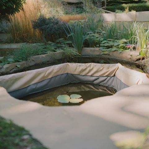 A durable pond liner in garden landscape.