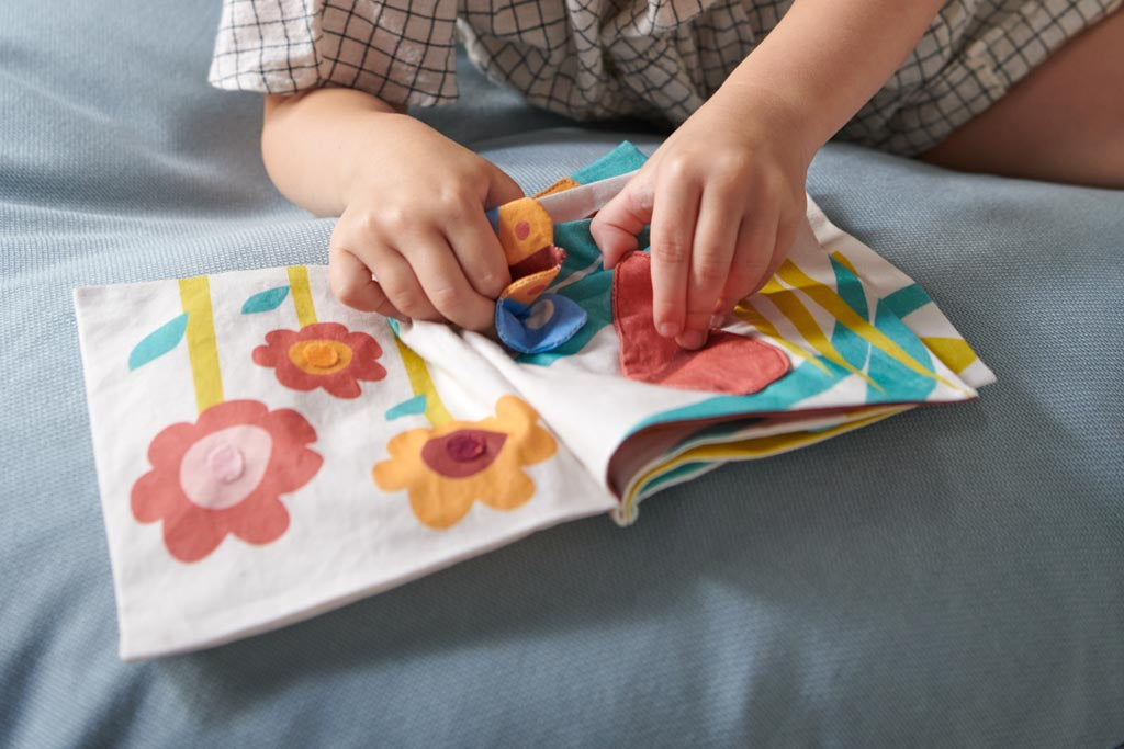A child playing with a rag book