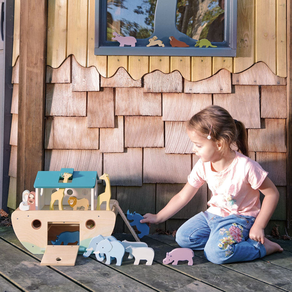 Child playing with wooden ark