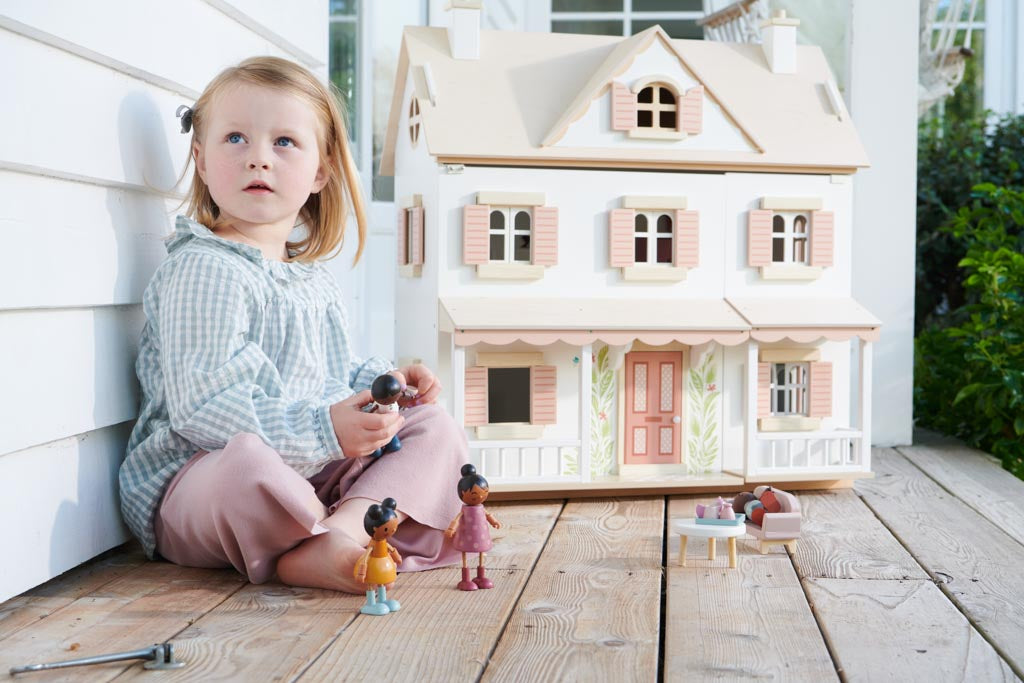 Girl playing with a doll's house