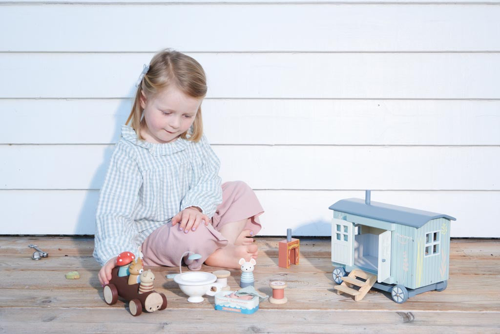 Girl playing with small world toys