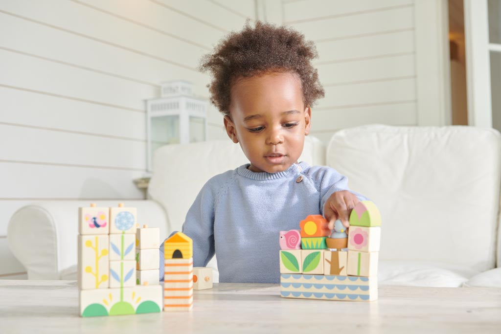 Toddler playing with wooden blocks