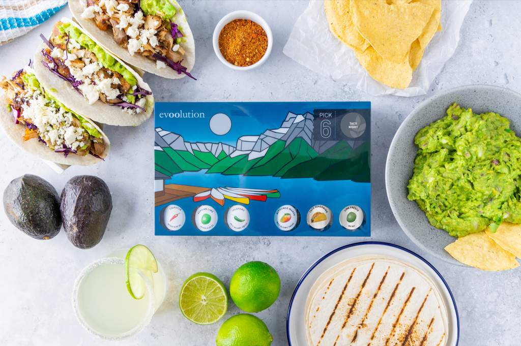 Evoolution's Pick6 Taco Night kit with tacos, guacamole, and margaritas surrounding