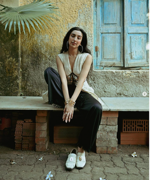 Image of Aditi Mayer sitting on a bench