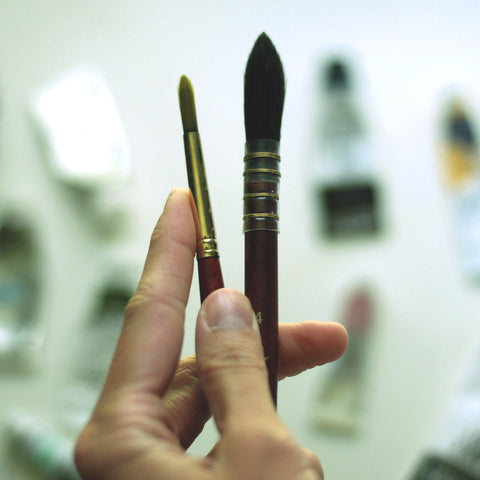 paintbrushes in a hand