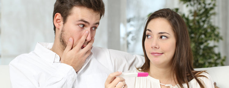 couple looking at pregnancy test result