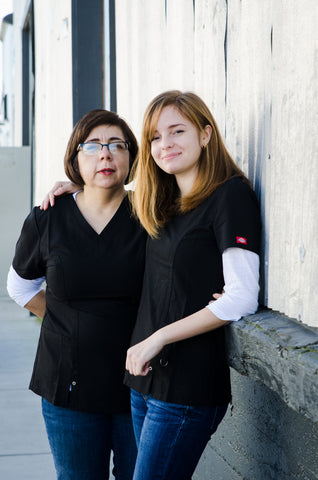 owner emma and her daughter posing outside