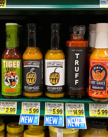 Sauce Bae Hot Sauce Harris Teeter Grocery Stores next to Truff and Siete
