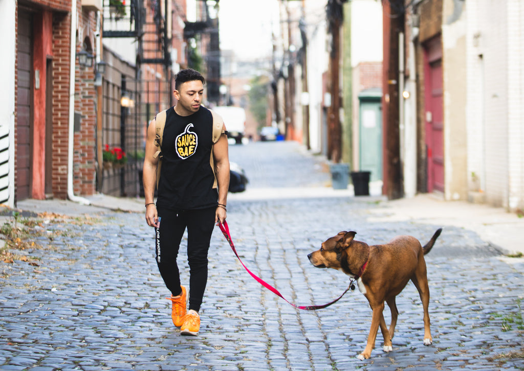 Sauce Bae founder Kevin Carbone walking his dog in Hoboken
