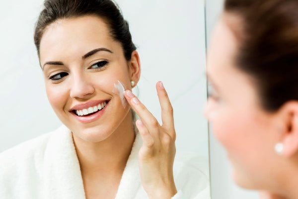 Applying moisturizer to face