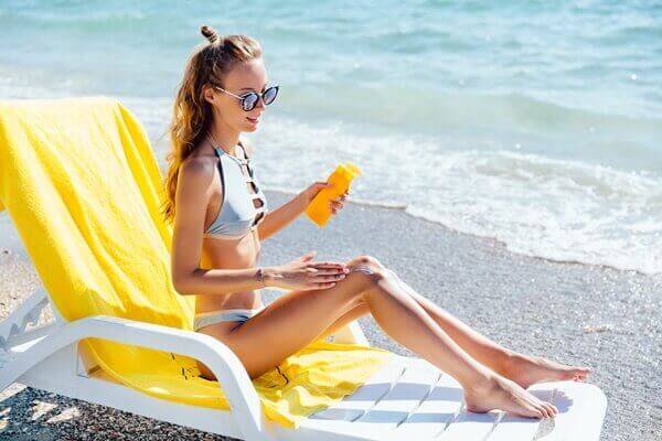 Woman applying sunscreen