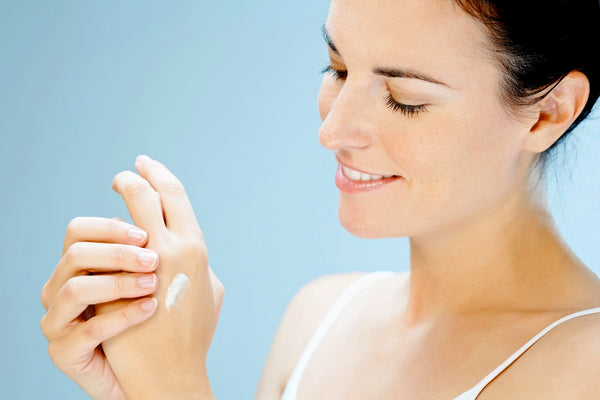 Applying moisturizer to hands