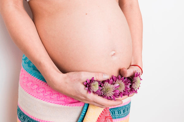 Pregnant woman holding flowers