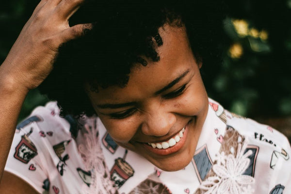 A laughing woman with kinky hair