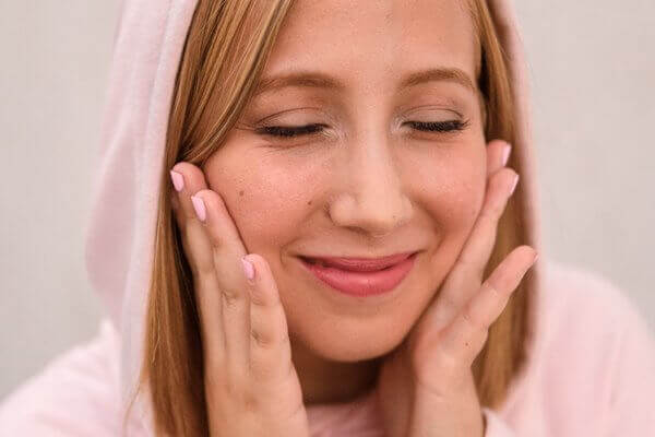 Woman touching her face