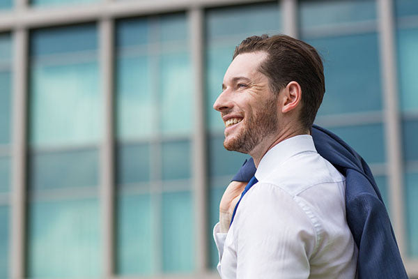 happy guy in front of a building