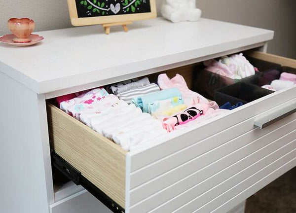 Organise baby clothes with drawer dividers