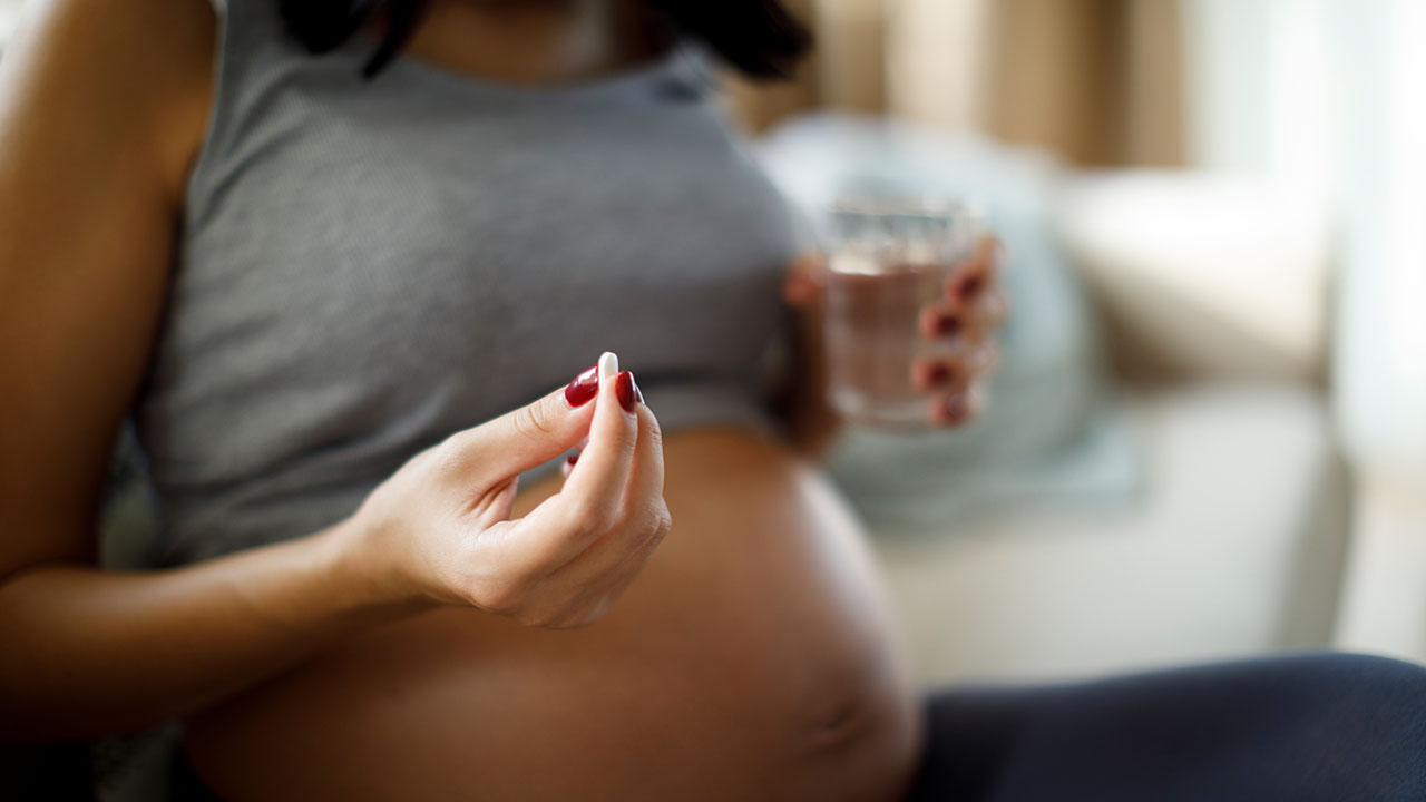 Pregnant women taking a supplement
