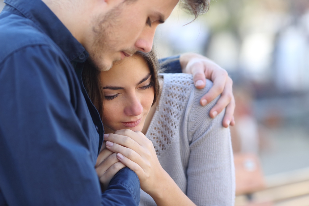 Man embracing women