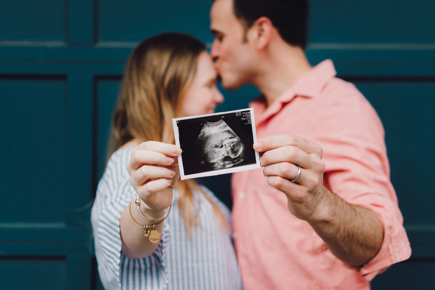 couple holding ultrasound image