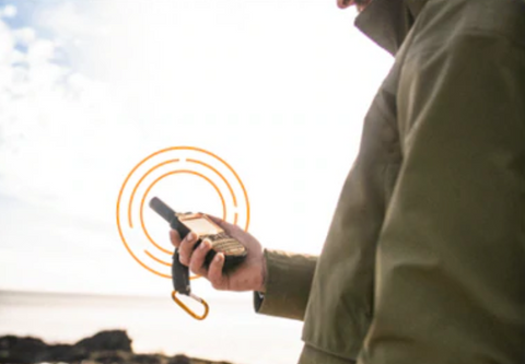 man using emergency messenger device