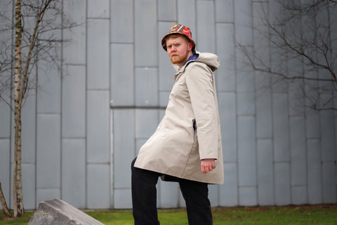 Man standing on slant in coat and bucket hat