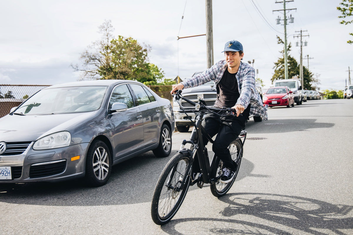 Man riding commuter eBike on city street