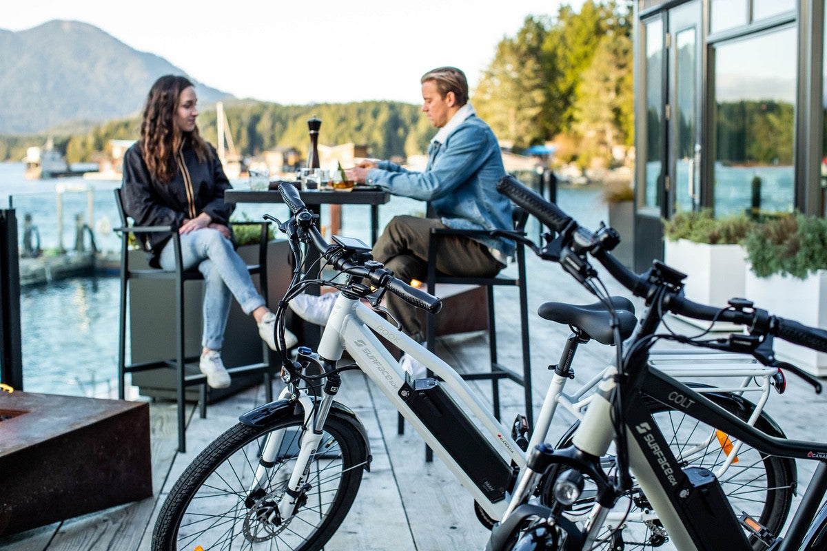 commuter eBikes in foreground with couple sitting outside