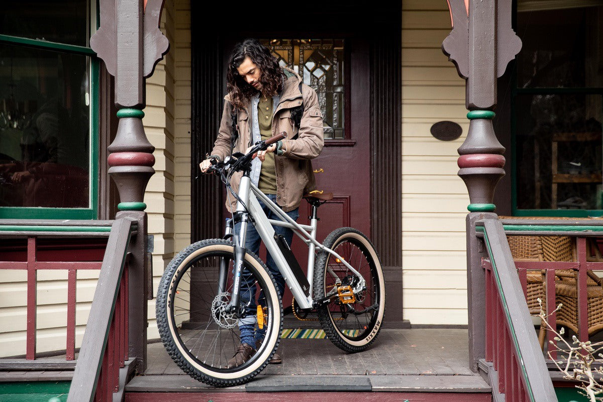 Man looking down at the handlebars of a Surface604 eBike