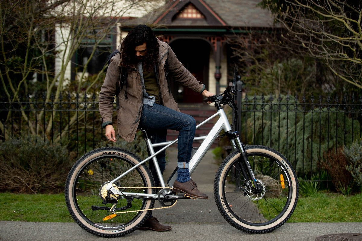 Man with foot on pedal of Surface 604 eBike equipped with torque sensors