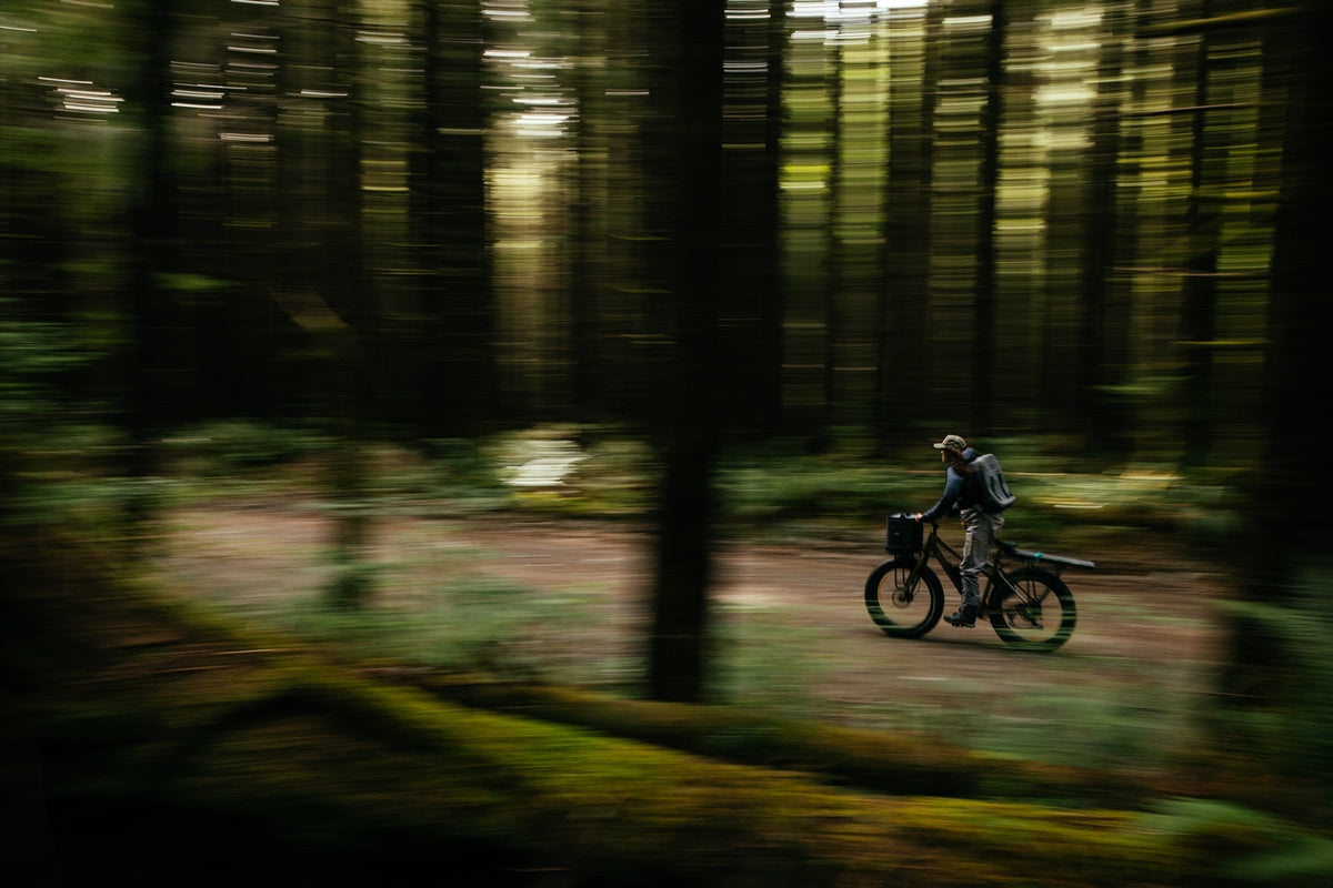 Woman riding fat tire eBike from Surface 604 with torque sensors through woods