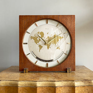 An impressive mid 20th Century World Timer mantel or table clock by Kienzle, Germany with the very rare teak wood surround. The face depicts the countries of the world showing the different time zones - SHOP NOW - www.intovintage.co.uk
