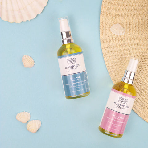 Body oils on a seaside backdrop with shells