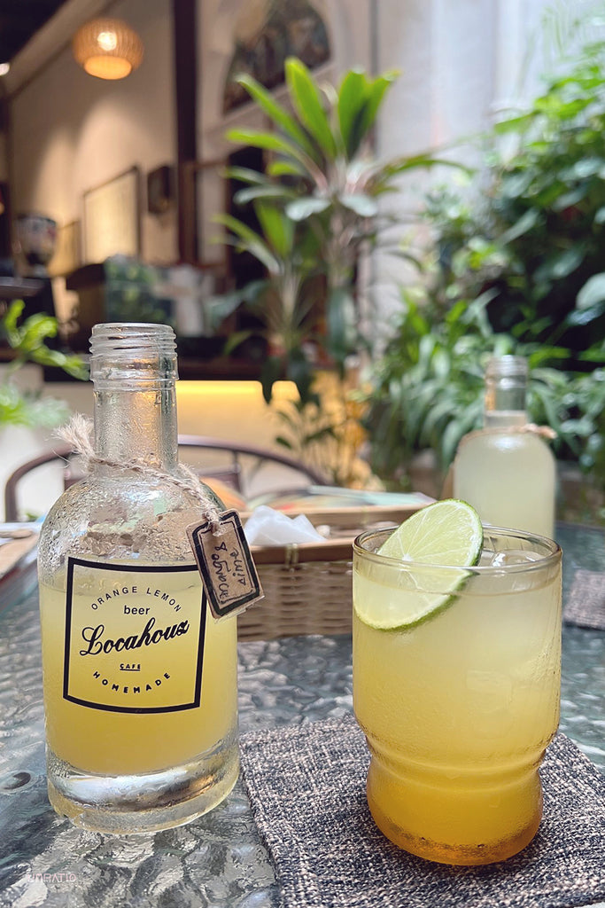Refreshing homemade orange lemon beer at Locahouz cafe in Melaka, served in a casual outdoor setting.