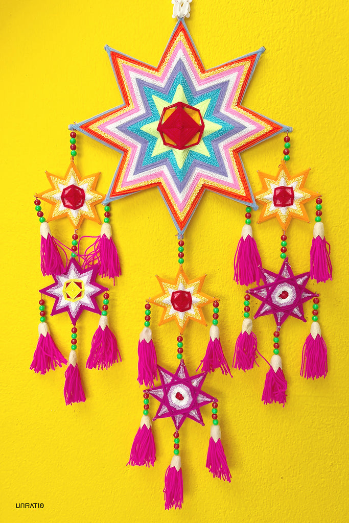 Handcrafted star-shaped lanterns with vivid patterns and tassels against a bold yellow background, reflecting the traditional art and cultural vibrancy of Loei, Thailand.