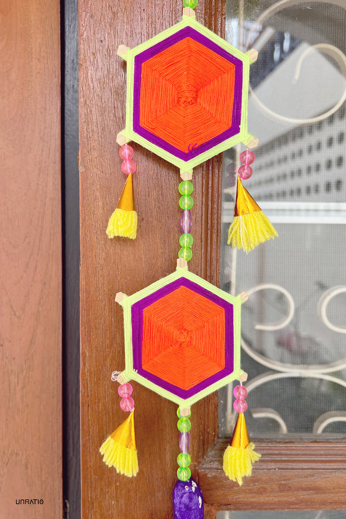 Colorful handwoven hexagonal Thai lanterns adorned with tassels, hanging against a wooden backdrop, bringing a touch of Loei's cultural craft to the decor