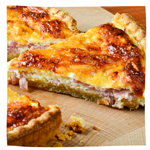 Ham and Cheese quiche on a wooden cutting board