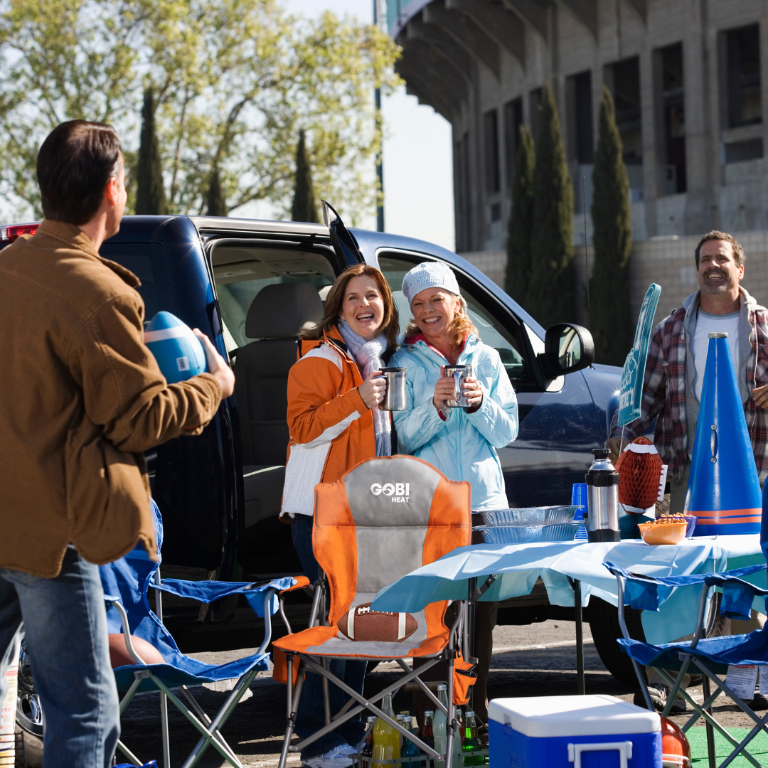 Fans enjoying a tailgate party with their gobi heat accessories