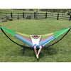 Large curved black metal stand on lawn with colourful hammock