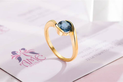 Natural London Blue Topaz Semi Bezel-Set Solitaire Ring in 14K Yellow Gold. Designed and made by AME Jewellery