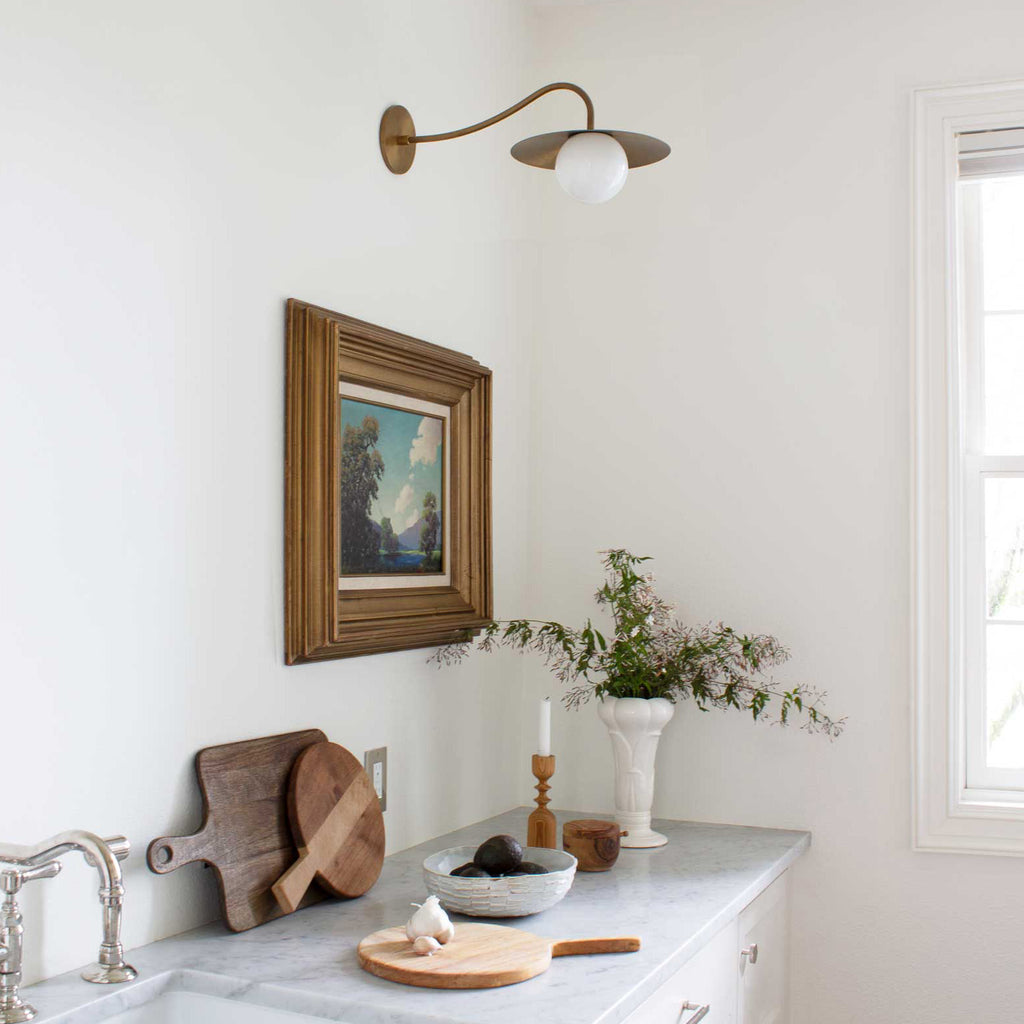 Marie Sconce shown in Heirloom Brass mixed with Polished Nickel plumbing fixtures.